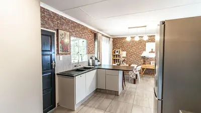 a kitchen with a counter and a brick wall at Cottage Protea in Doornrandjies
