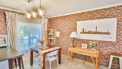 a living room with a brick wall at Cottage Protea in Doornrandjies
