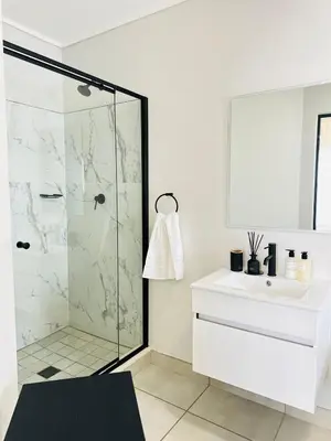 a bathroom with a shower and a sink at Lagoon Luxury Stay 2 bed apartment at The Blyde in Pretoria