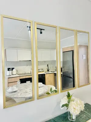 a kitchen with three mirrors on a wall at Lagoon Luxury Stay 2 bed apartment at The Blyde in Pretoria