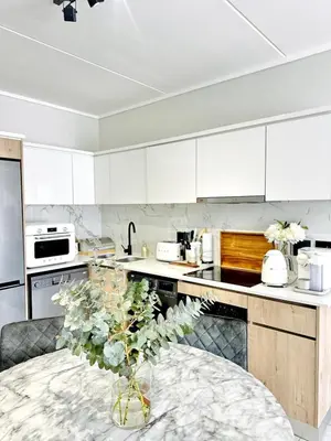 a kitchen with a table with a vase on it at Lagoon Luxury Stay 2 bed apartment at The Blyde in Pretoria