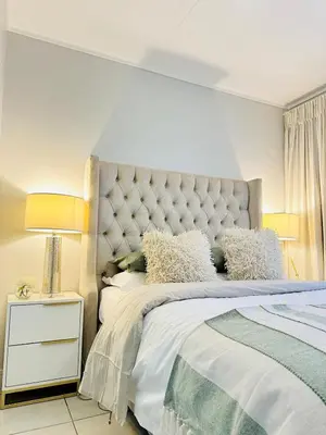 a white bedroom with a large bed and two lamps at Lagoon Luxury Stay 2 bed apartment at The Blyde in Pretoria