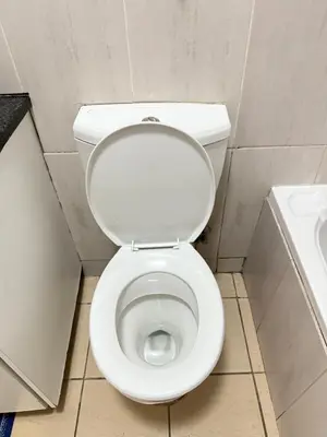 a bathroom with a white toilet and a sink at 2 bed room apartment in the heart of midrand in Erand