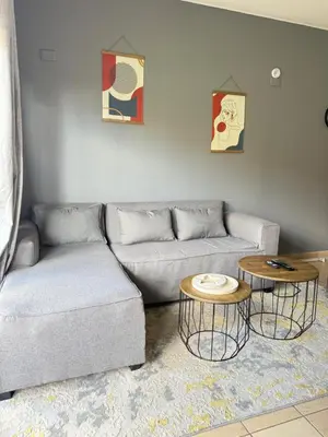 a living room with a couch and two tables at 2 bed room apartment in the heart of midrand in Erand