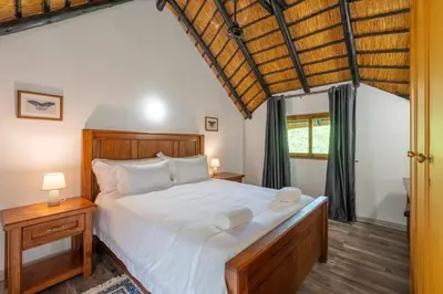 a bedroom with a large bed and a window at Kruger Park Lodge Unit No 219 in Hazyview