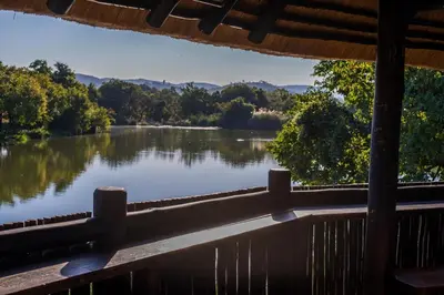 a view of a lake from the porch of a cabin at Kruger Park Lodge Unit No 219 in Hazyview