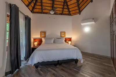a bedroom with a large bed in a room at Kruger Park Lodge Unit No 219 in Hazyview
