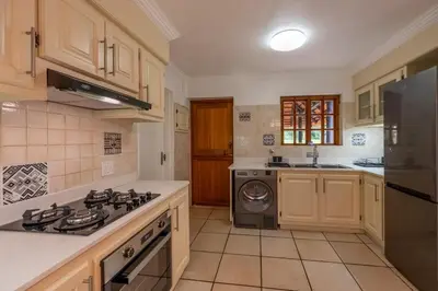 a kitchen with a stove and a dishwasher at Kruger Park Lodge Unit No 219 in Hazyview