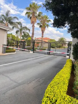 an empty street with a fence and palm trees at Midrand Urban Escape in Midrand