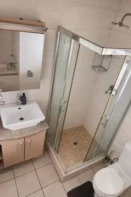 a bathroom with a shower and a sink at Midrand Urban Escape in Midrand
