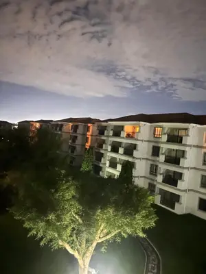 an apartment building with a tree in front of it at Midrand Urban Escape in Midrand