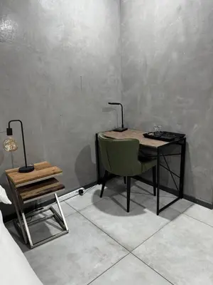 a desk with a chair and a table with a lamp at Bras boutique in Steelpoort