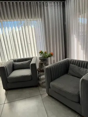 a living room with two chairs and a couch and a window at Bras boutique in Steelpoort