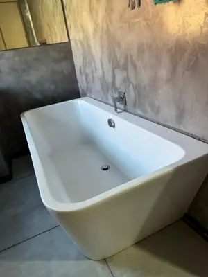 a white bath tub sitting in a bathroom at Bras boutique in Steelpoort