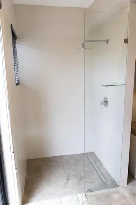 a shower with a glass door in a bathroom at Villa Kolobe in Hoedspruit