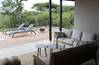 a living room with a couch and chairs on a deck at Villa Kolobe in Hoedspruit