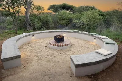a fire pit with a candle in the middle at Villa Kolobe in Hoedspruit