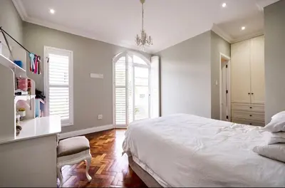 a bedroom with a large white bed and two windows at The Residence in Midrand