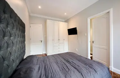 a bedroom with a large bed and a tv at The Residence in Midrand