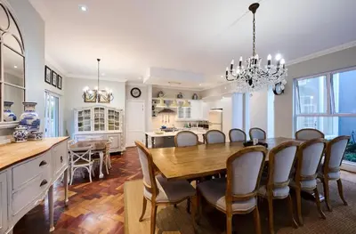 a kitchen and dining room with a table and chairs at The Residence in Midrand