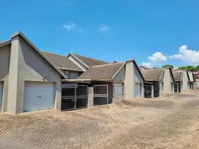 a row of houses on a brick driveway at Country Villa in Nelspruit