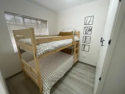 a bedroom with two bunk beds in a room at Country Villa in Nelspruit