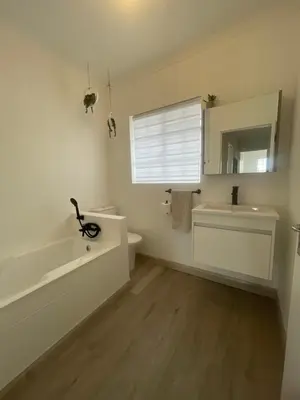 a bathroom with a sink and a toilet and a mirror at Country Villa in Nelspruit