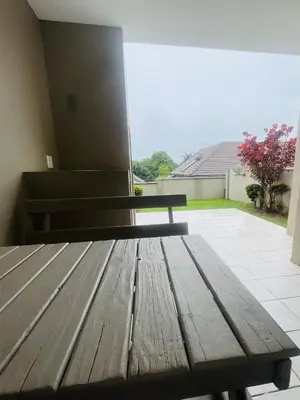 a wooden bench sitting on top of a porch at Country Villa in Nelspruit