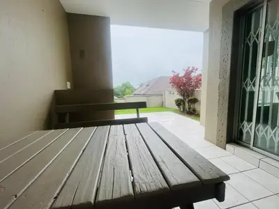 a wooden bench in a room with a window at Country Villa in Nelspruit