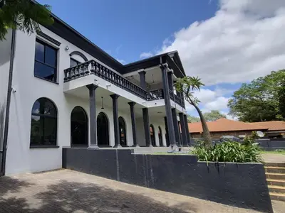 an exterior view of a white house at Namloom Guesthouse in Pretoria