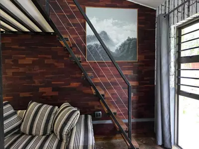 a couch in a room with a brick wall at Stayfit 04 in Polokwane
