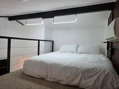 a bedroom with a white bed and two lights at Stayfit 04 in Polokwane