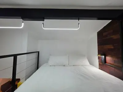 a white bed in a room with two lights at Stayfit 04 in Polokwane