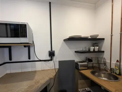 a kitchen with a counter with a microwave and a sink at Stayfit 04 in Polokwane