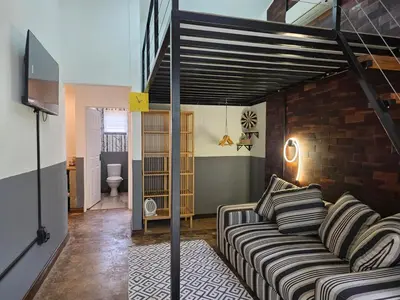 a living room with a couch and a loft at Stayfit 04 in Polokwane