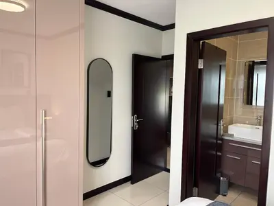 a bathroom with a mirror and a black door at Cozy retreat in Bluehills in Midrand