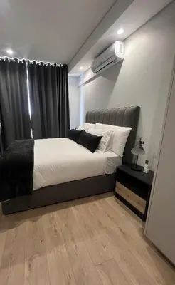 a bedroom with a large bed and a window at Maboneng at Ellipse Waterfall in Midrand