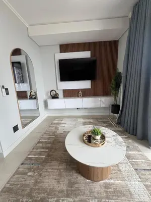 a living room with a tv and a coffee table at LeeMo at Ellipse Waterfall in Midrand