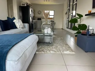 a living room with a couch and a coffee table at Modern and Elegant Cozy Living in Midrand