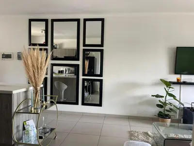 a living room with black framed windows at Modern and Elegant Cozy Living in Midrand