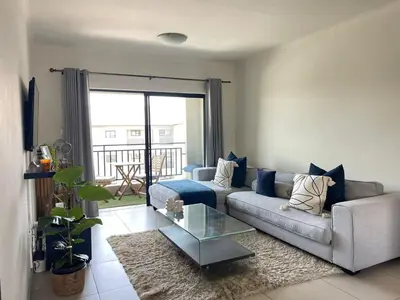 a living room with a couch and a glass table at Modern and Elegant Cozy Living in Midrand
