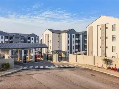 a parking lot in front of some apartment buildings at Modern and Elegant Cozy Living in Midrand