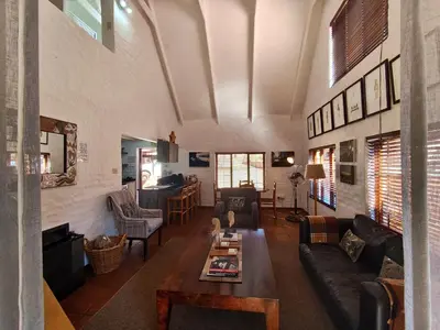a living room with a couch and a table at Delagoa Cottage Dullstroom in Dullstroom