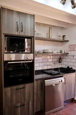a kitchen with a stainless steel oven and appliances at Delagoa Cottage Dullstroom in Dullstroom
