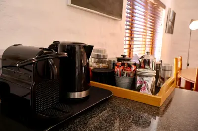 a coffee maker on a counter in a kitchen at Delagoa Cottage Dullstroom in Dullstroom