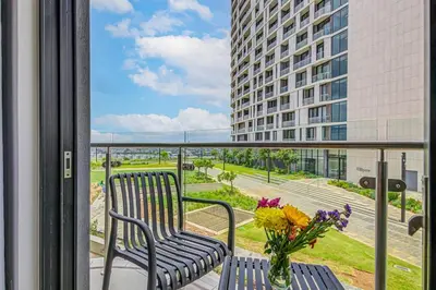 a balcony with two benches and a vase of flowers at Studio apartment, Ellipse Waterfall in Midrand