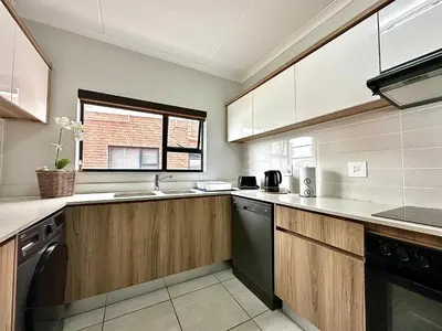 a kitchen with a sink and a dishwasher at The Blyde - 3 Bedroom Lagoon Facing Luxury Apartment in Pretoria