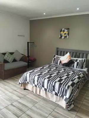a bedroom with a bed and a couch at Bredell Motel in Bredell