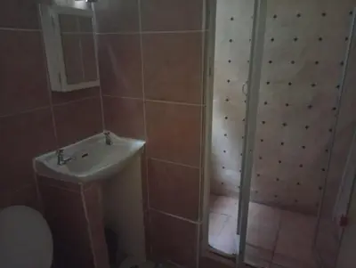 a bathroom with a shower and a sink at Manoutsa Holiday Resort in Hoedspruit