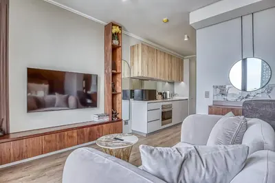 a living room with two couches and a kitchen at The Oud at Ellipse Waterfall in Vosburg